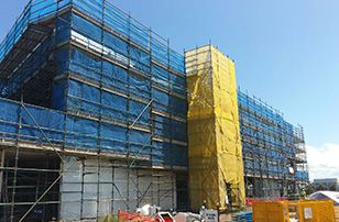 blue and yellow fall protection solutions on a construction project